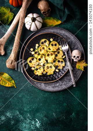 Halloween food. Marinated cucumber in shape of skull Halloween food. Marinated cucumber in shape of skull 143074180