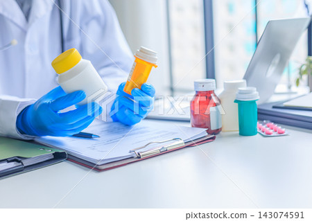 Doctor review patient medical history and managing prescriptions for patient. 143074591