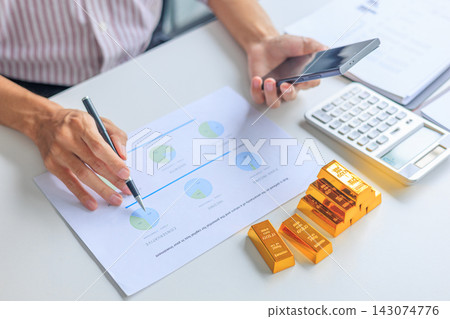 Close-up hands using smartphone for gold bar trading and managing account. Concept for gold wealth management, asset protection, and financial planning. Close-up hands using smartphone for gold bar trading and managing account. Concept for gold wealth management, asset protection, and financial planning. 143074776