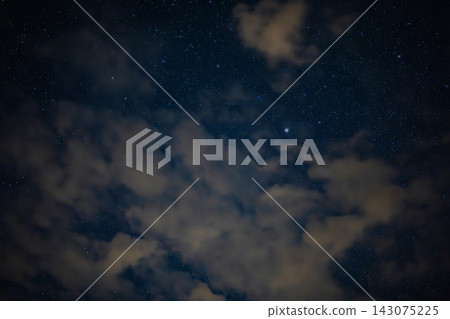 Night Sky with Stars and Wispy Clouds in a Deep Blue Backdrop Night Sky with Stars and Wispy Clouds in a Deep Blue Backdrop 143075225
