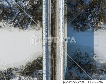 Aerial winter bridge over frozen wetland in rural Belarus Aerial winter bridge over frozen wetland in rural Belarus 143075287