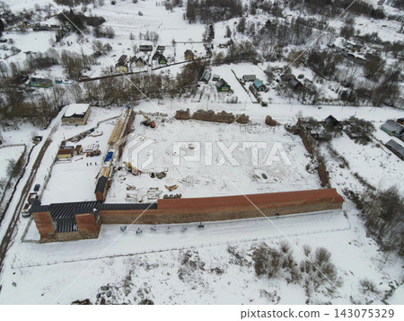 Aerial winter view of Belarus fortress ruins with red roof and towers Aerial winter view of Belarus fortress ruins with red roof and towers 143075329