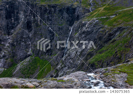 Mountain canyon with cascading waterfall, moss-covered cliff face, and alpine stream, Norway Mountain canyon with cascading waterfall, moss-covered cliff face, and alpine stream, Norway 143075365