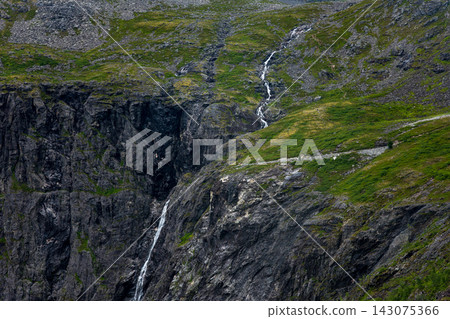 Aerial view of mountainous terrain with cascading waterfalls and moss-covered slopes, Norway 143075366
