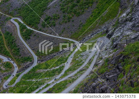 Aerial view of serpentine mountain road with hairpin turns, Norway 143075378