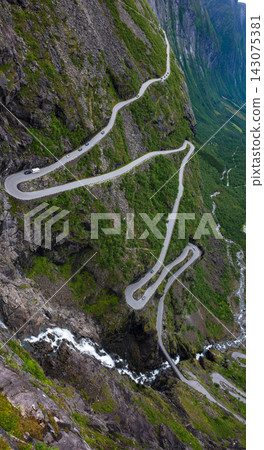 Aerial view of winding mountain road on steep alpine slope, Norway 143075381