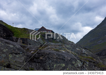 Red house on moss-covered hillside in mountain valley, Norway Red house on moss-covered hillside in mountain valley, Norway 143075413