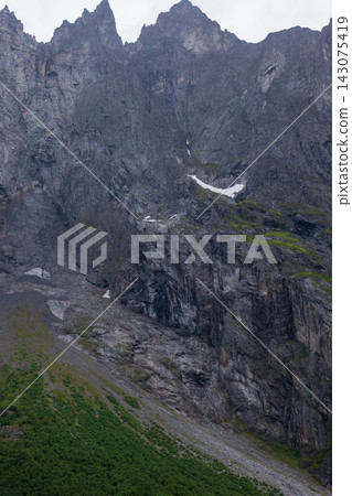Aerial view of steep limestone gorge with waterfall and moss vegetation, Norway 143075419