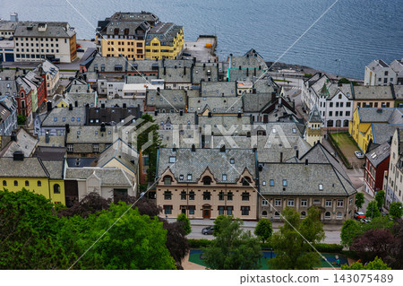Aerial view of coastal town with traditional architecture, stone buildings and harbor, Norway Aerial view of coastal town with traditional architecture, stone buildings and harbor, Norway 143075489