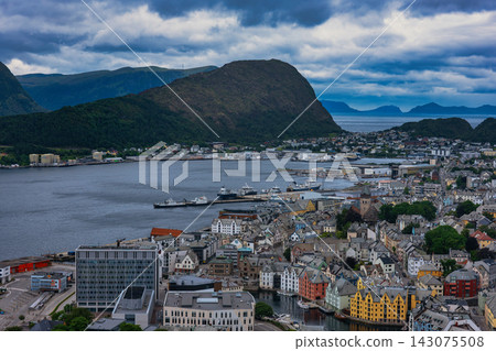 Aerial view of Aalesund harbor and fjord settlement with surrounding mountains, Norway Aerial view of Aalesund harbor and fjord settlement with surrounding mountains, Norway 143075508