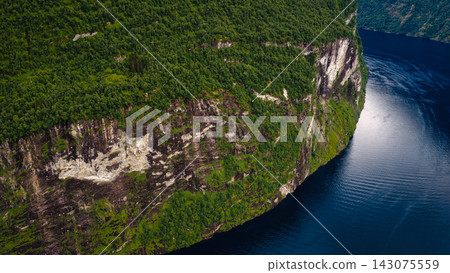 Aerial view of forested fjord cliffs with deep water near Mollsaeter, Norway Aerial view of forested fjord cliffs with deep water near Mollsaeter, Norway 143075559