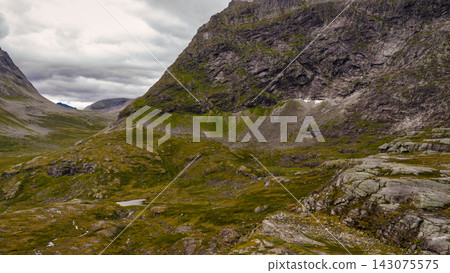 Alpine valley with moss-covered slopes and rocky outcrops, Norway highlands Alpine valley with moss-covered slopes and rocky outcrops, Norway highlands 143075575