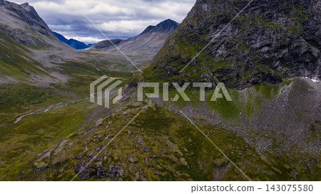 Mountain valley with moss-covered slopes and stream, Rauma region Norway Mountain valley with moss-covered slopes and stream, Rauma region Norway 143075580