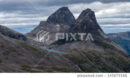 Alpine peaks with glacial lake and scree fields, Rauma Mountains Norway Alpine peaks with glacial lake and scree fields, Rauma Mountains Norway 143075588
