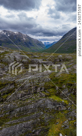 Alpine valley with rocky terrain and mountains, Rauma Norway Alpine valley with rocky terrain and mountains, Rauma Norway 143075597