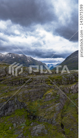 Mountain valley view with rocky terrain and moss coverage, Rauma Norway 143075599