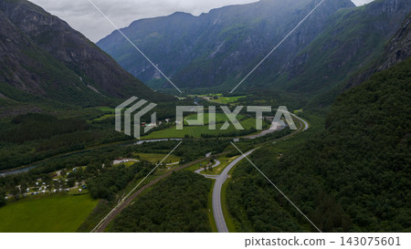 Aerial view of Rauma valley with river meanders, road, and railway, Eidet Norway Aerial view of Rauma valley with river meanders, road, and railway, Eidet Norway 143075601