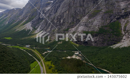 Aerial view of Romboleden valley near Eidet, Rauma, Norway with river meanders and cliff formations Aerial view of Romboleden valley near Eidet, Rauma, Norway with river meanders and cliff formations 143075602