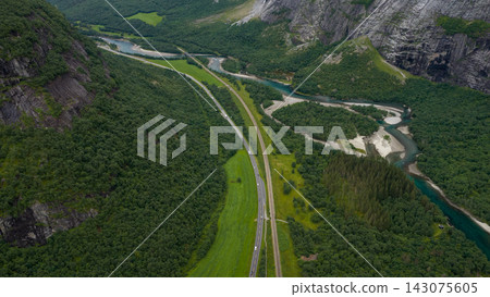 Aerial view of dual highway through Rauma valley with meandering river, Eidet Norway Aerial view of dual highway through Rauma valley with meandering river, Eidet Norway 143075605