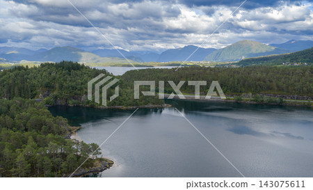 Aerial view of forested lake basin with mountains, Straumen Norway Aerial view of forested lake basin with mountains, Straumen Norway 143075611