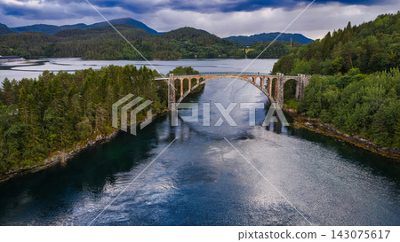 Aerial view of stone arch bridge crossing river valley, Straumen Norway Aerial view of stone arch bridge crossing river valley, Straumen Norway 143075617