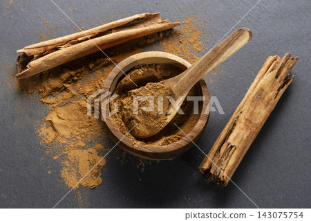 Cinnamon Sticks and Powder on Gray Slate 143075754