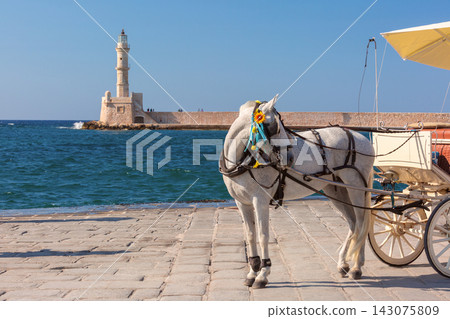Horse Drawn Carriage by Chania Lighthouse in Crete, Greece Horse Drawn Carriage by Chania Lighthouse in Crete, Greece 143075809