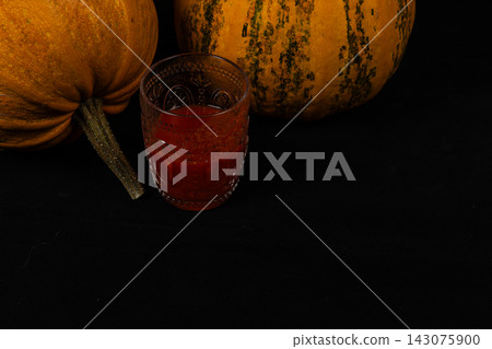 Pumpkins and a drink create a festive atmosphere for Halloween season Pumpkins and a drink create a festive atmosphere for Halloween season 143075900