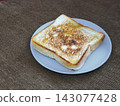 Top view of freshly grilled toasted bread served on a plate, a popular Indonesian street food snack known as ropang. 143077428