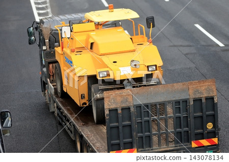 Truck transporting tire rollers Truck transporting tire rollers 143078134