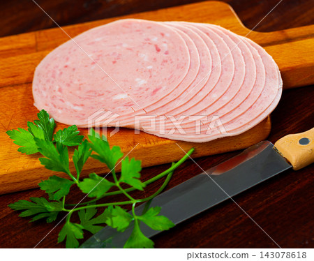 Sliced ham on wooden background Sliced ham on wooden background 143078618