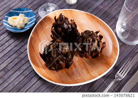 Delicious roasted artichokes served with garlic aioli sauce Delicious roasted artichokes served with garlic aioli sauce 143078621