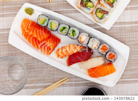 On table there portion set with maki, sashimi and nigiri On table there portion set with maki, sashimi and nigiri 143078622