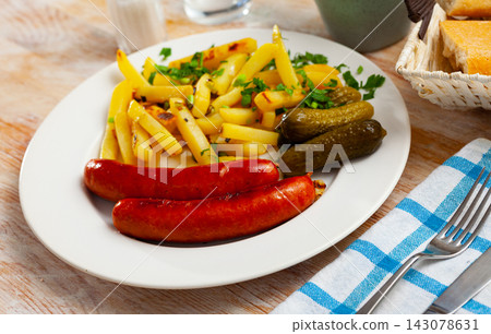 Sausages with potatoes and pickled cucumbers 143078631