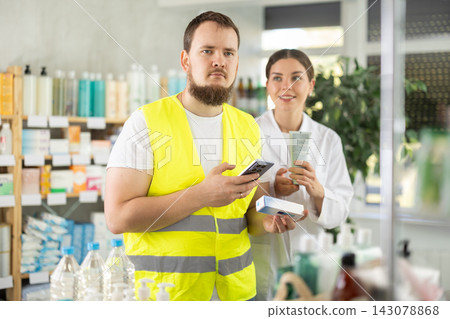 builder scans an ointment pack in a pharmacy builder scans an ointment pack in a pharmacy 143078868