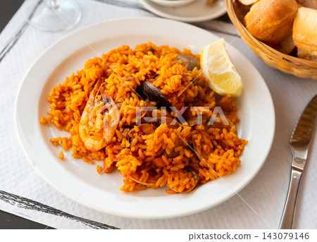 Paella on white plate Paella on white plate 143079146