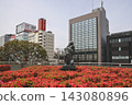 April 30 2026 Koriyama city sculpture with flowers and modern buildings 143080896