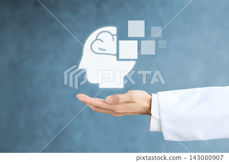 醫生和研究人員的手拿著代表癡呆症患者的圖標。 醫生和研究人員的手拿著代表癡呆症患者的圖標。 143080907