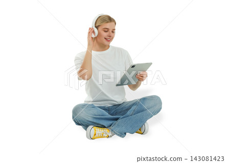 Woman listens to music and browses content on tablet while seated, PNG Woman listens to music and browses content on tablet while seated, PNG 143081423