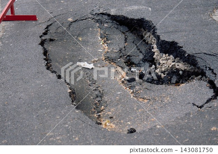 Deep Asphalt Pothole and Road Damage on City Street Deep Asphalt Pothole and Road Damage on City Street 143081750