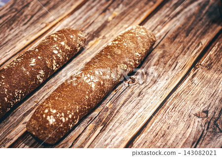 Artisan Whole Grain Bread on Rustic Wooden Table Artisan Whole Grain Bread on Rustic Wooden Table 143082021