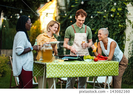 Friends enjoying summer barbecue party in backyard garden Friends enjoying summer barbecue party in backyard garden 143082160