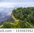 Aerial View of Forest Peninsula on a Calm Lake in Latvia 143083942
