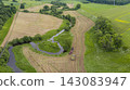 Aerial View of River Bend and Farmland with Tractor 143083947