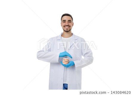 Smiling doctor shows a dental model, isolated, PNG Smiling doctor shows a dental model, isolated, PNG 143084620