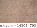 Dark Brown leather background with cracked texture full frame faux leatherette grain pattern. 143084793