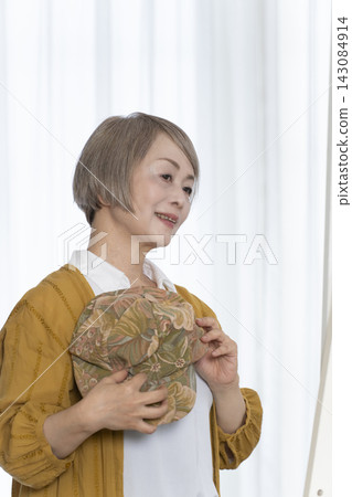 Senior women choosing hats and dressing stylishly Senior women choosing hats and dressing stylishly 143084914
