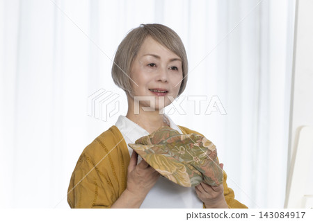 老年婦女挑選帽子和穿著時尚 143084917