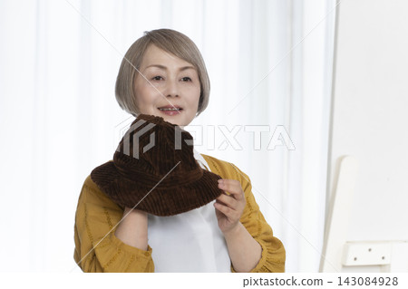Senior women choosing hats and dressing stylishly Senior women choosing hats and dressing stylishly 143084928