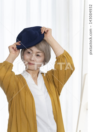 Senior women choosing hats and dressing stylishly Senior women choosing hats and dressing stylishly 143084932